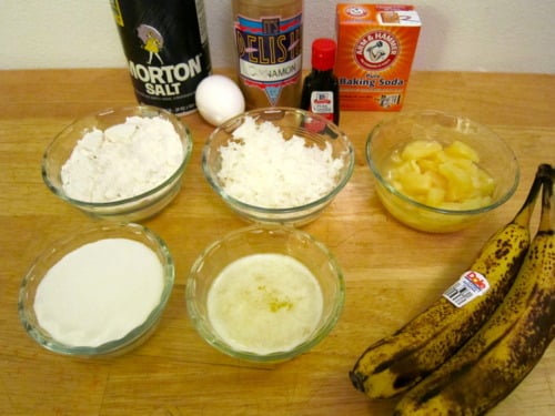 Ingredients for banana coconut pineapple muffins including ripe bananas, crushed pineapple, shredded coconut, flour, sugar, egg, melted butter, salt, cinnamon, baking soda, and vanilla extract.