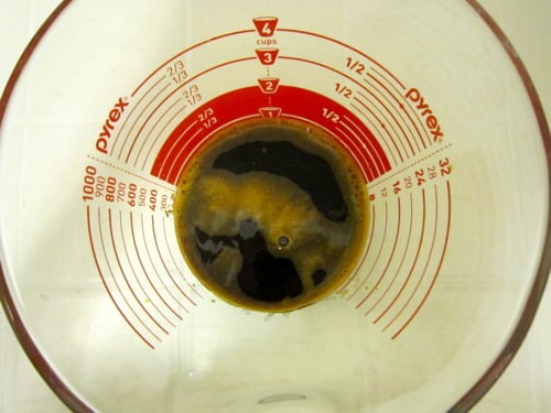 Freshly brewed espresso in a glass measuring cup for mocha muffin batter.