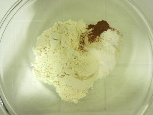 Dry ingredients including flour, baking powder, and cinnamon combined in a mixing bowl.