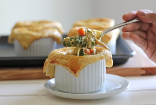 Mini chicken pot pie with a puff pastry crust in a ramekin.