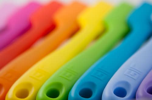 Close-up of colorful spatula arranged in a row