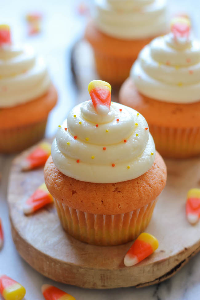 Candy Corn Cupcakes - These simple vanilla cupcakes can easily be dressed up to resemble the layers of candy corn goodness!