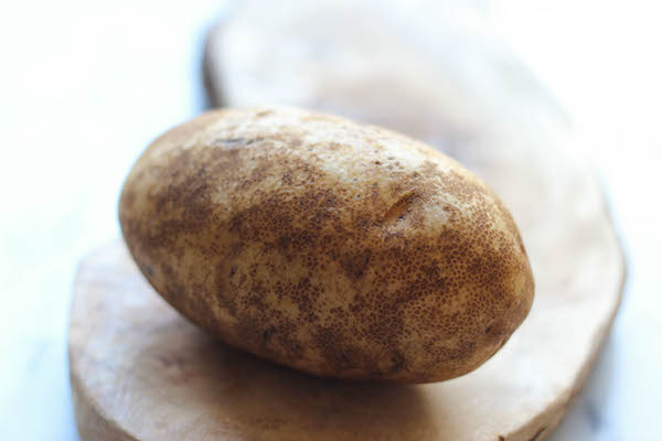 Loaded Hasselback Potatoes - A glorified baked potato loaded with melted cheddar cheese, sour cream, and crisp bacon bits!