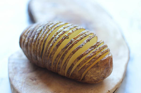Loaded Hasselback Potatoes - A glorified baked potato loaded with melted cheddar cheese, sour cream, and crisp bacon bits!