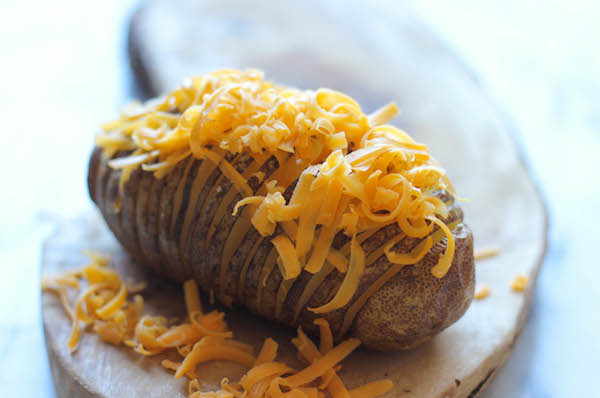 Loaded Hasselback Potatoes - A glorified baked potato loaded with melted cheddar cheese, sour cream, and crisp bacon bits!