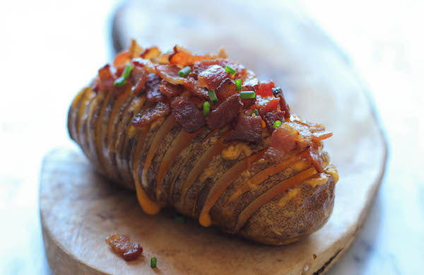 Loaded Hasselback Potatoes - A glorified baked potato loaded with melted cheddar cheese, sour cream, and crisp bacon bits!