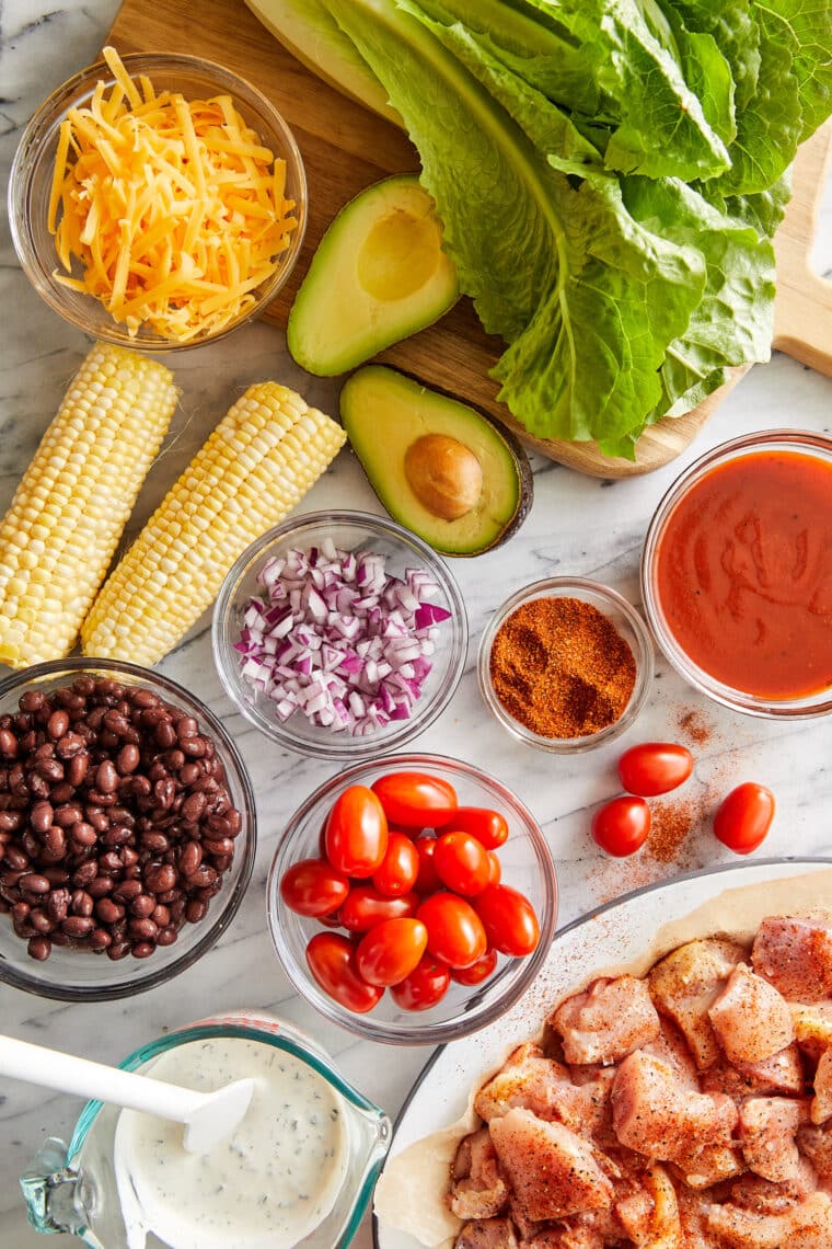 BBQ Chicken Salad - Smoky BBQ chicken, corn, tomatoes, black beans, avocado + cheese drizzled with homemade Ranch. An instant family favorite!