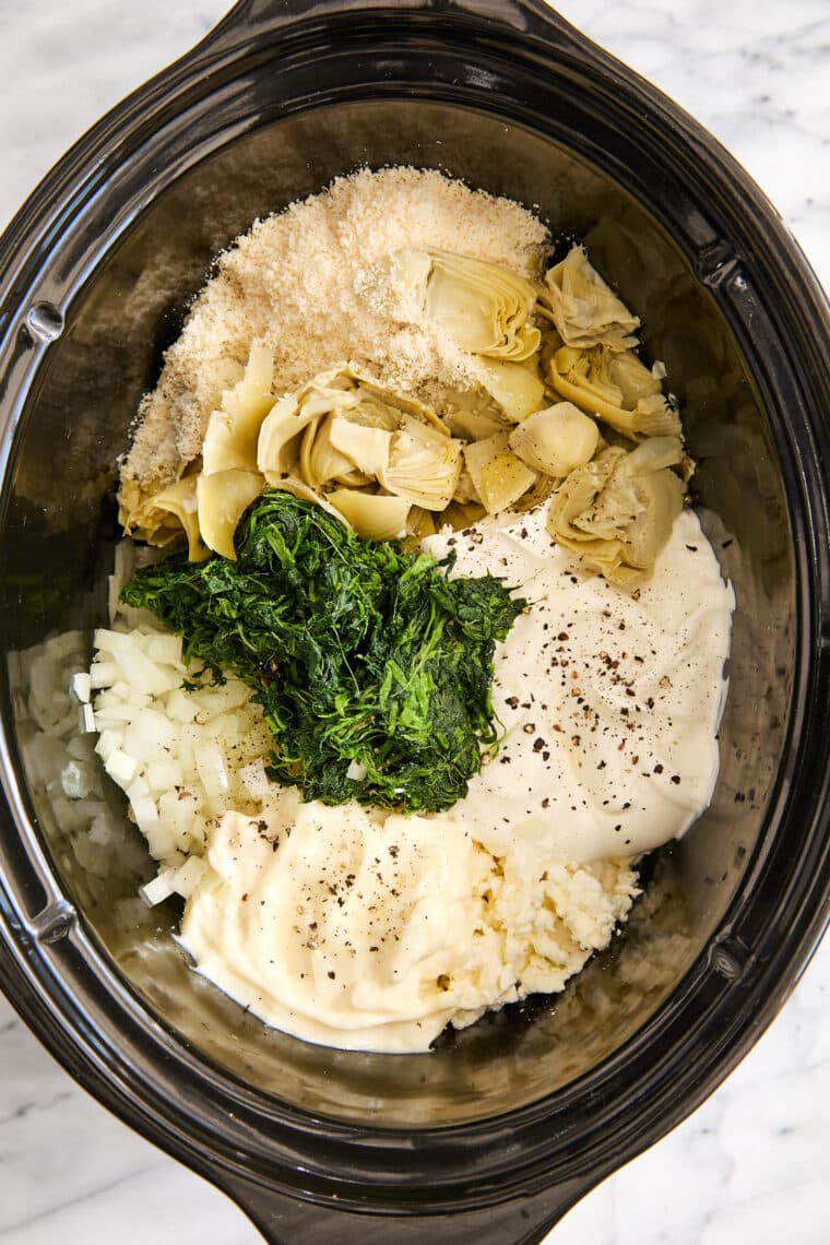 Slow Cooker Spinach and Artichoke Dip - Dump and go, set and forget right into the crockpot for the best and easiest cheesy, creamy dip ever!