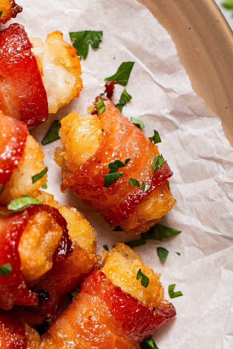 close up of bacon wrapped tater tot bombs garnished with parsley