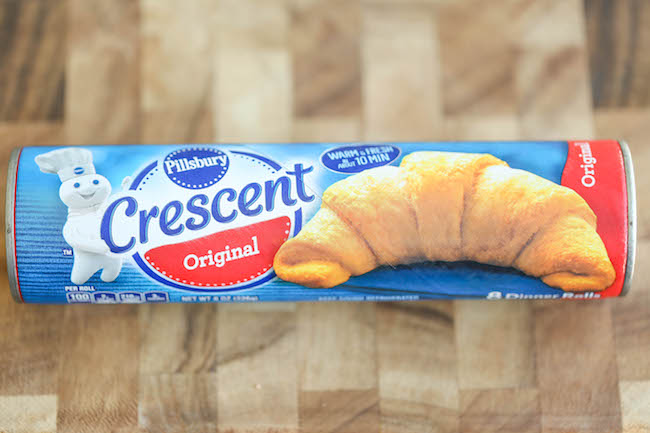 Spinach and Artichoke Dip Roll Ups - Everyone's favorite dip is stuffed into a flaky, buttery crescent roll, oozing with all that melted cheesy goodness!