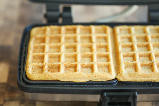 Pumpkin Churro Waffles - Light, fluffy, melt-in-your mouth pumpkin waffles coated in buttery cinnamon sugar and drizzled with a cream cheese glaze! Amazing.
