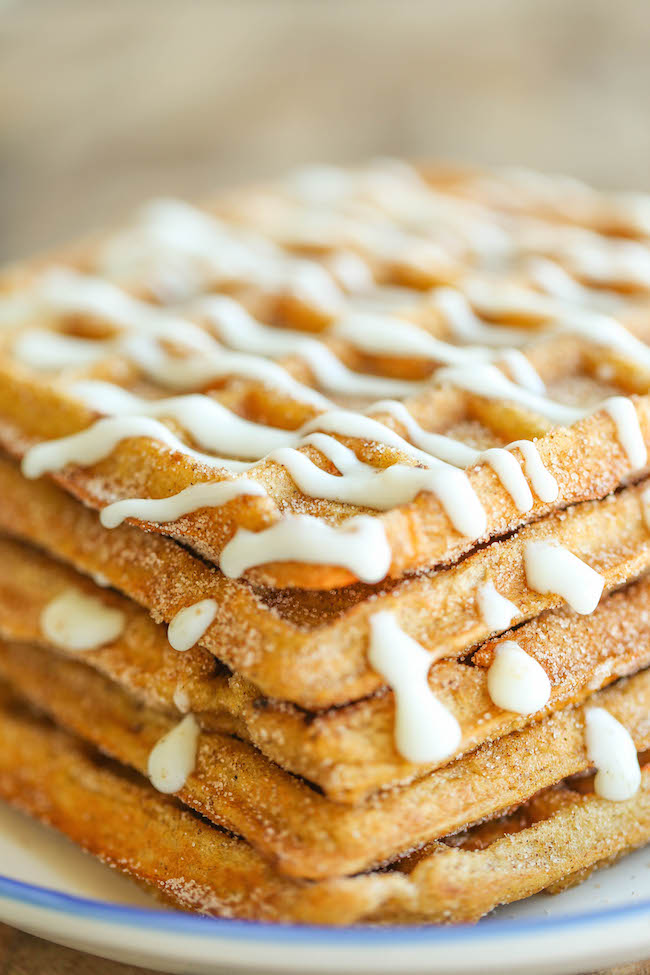 Pumpkin Churro Waffles - Light, fluffy, melt-in-your mouth pumpkin waffles coated in buttery cinnamon sugar and drizzled with a cream cheese glaze! Amazing.