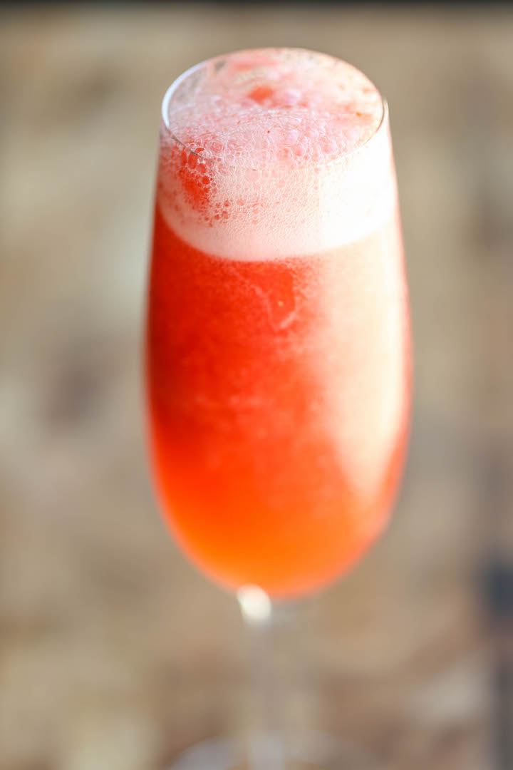 Strawberry Lemonade Bellini - This is a fun twist to your traditional peach bellini, made into a boozy-type slushy using only 4 ingredients with 5 min prep!