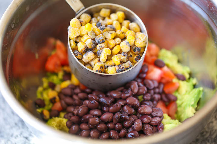 Southwestern Egg Rolls with Cilantro Avocado Sauce - Loaded with avocado, corn, beans and tomatoes! And you'll never guess that it's completely baked!