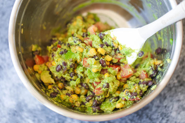 Southwestern Egg Rolls with Cilantro Avocado Sauce - Loaded with avocado, corn, beans and tomatoes! And you'll never guess that it's completely baked!