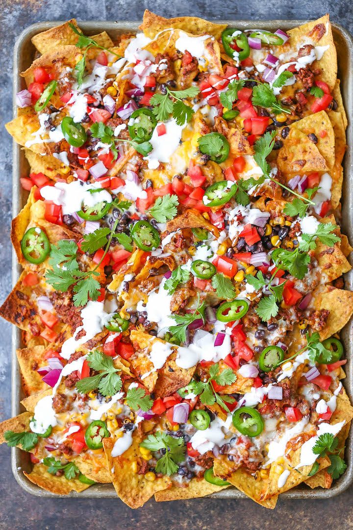 Sheet Pan Nachos - Loaded nachos that are guaranteed to be a crowd-pleaser! Simply layer your toppings, bake onto a sheet pan and serve. Done. Easy peasy!