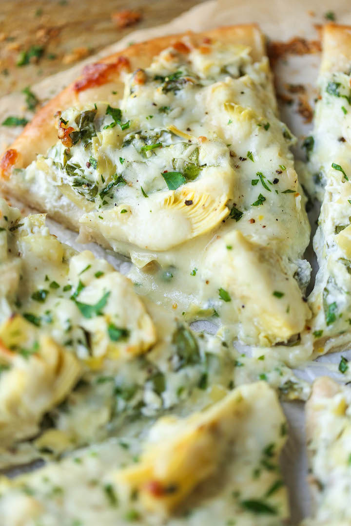 Spinach and Artichoke Dip Pizza - Everyone's favorite classic dip is turned into a pizza! It's so cheesy, utterly creamy and melt-in-your-mouth AH-MAZING!