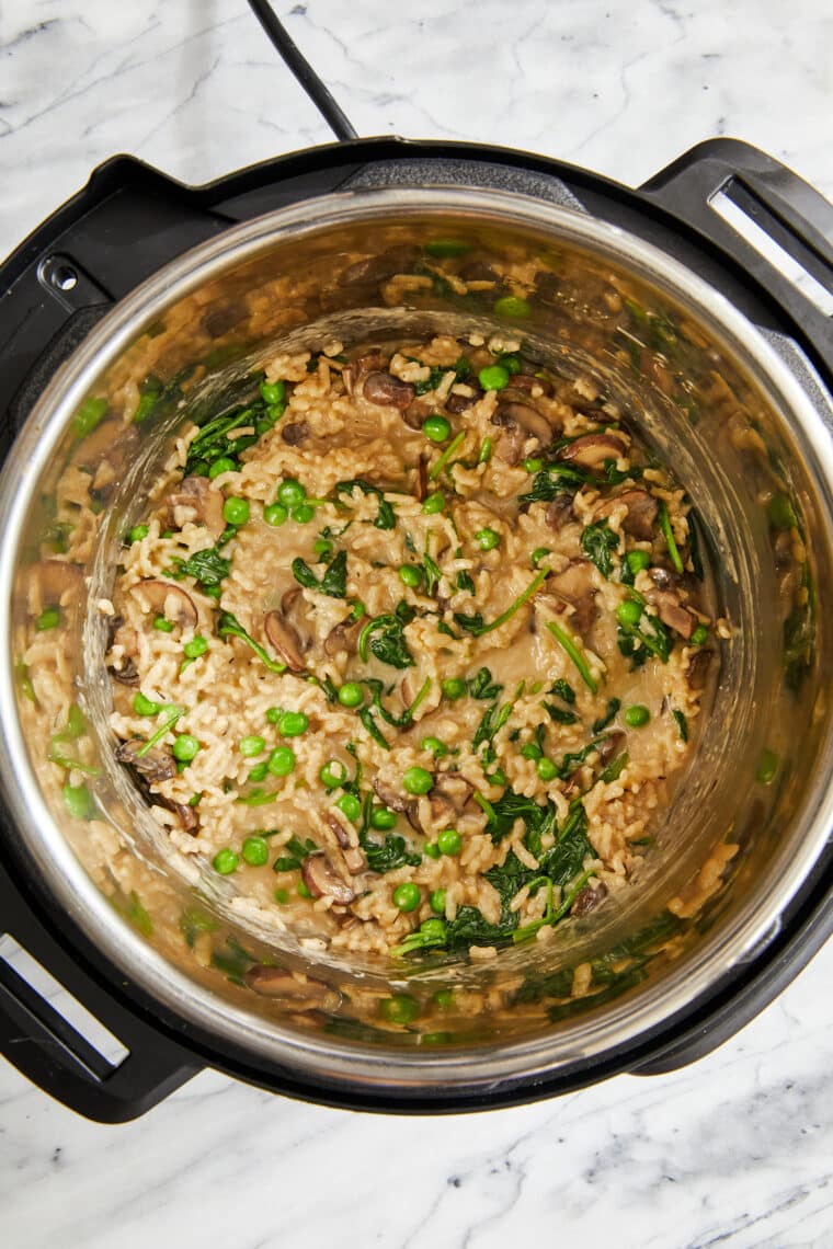 Instant Pot Mushroom Risotto - Truly the EASIEST no-fuss risotto! Amazingly rich + creamy, loaded with mushrooms, spinach, peas and Parmesan!