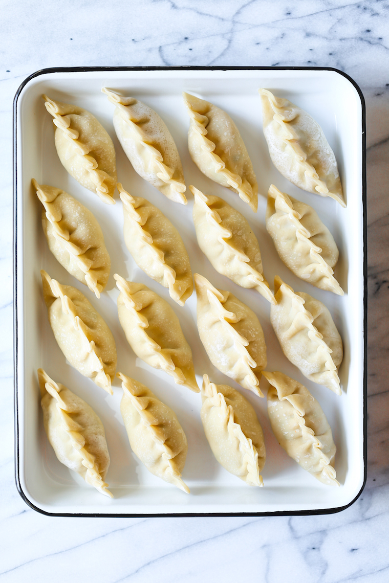 Pork and Kimchi Potstickers - Easy peasy potstickers! Perfectly crispy + a crowd-favorite with an amazing pork-kimchi filling! BONUS: it's freezer-friendly.