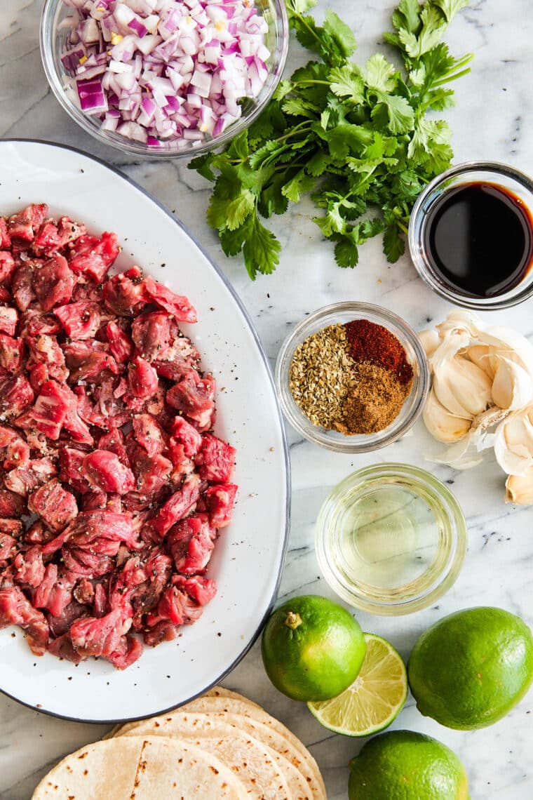 Carne asada steak cooking in cast iron skillet for Mexican street tacos