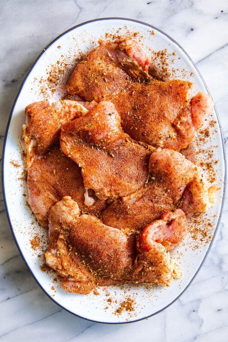 Assembled chicken tacos with tortillas, pico de gallo, avocado, and lime