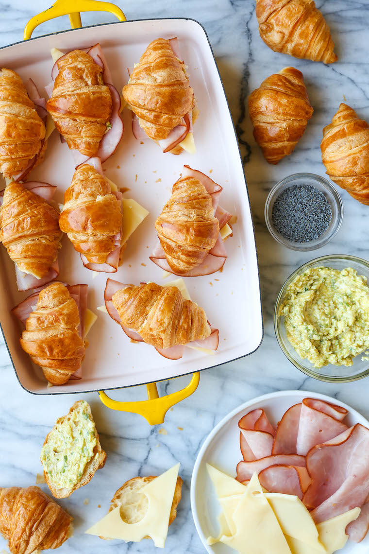 Baked Ham and Cheese Croissants - So so easy to make for a crowd! The mini croissants are toasted and flaky, baked with Dijon-honey, buttery goodness. WHOA.