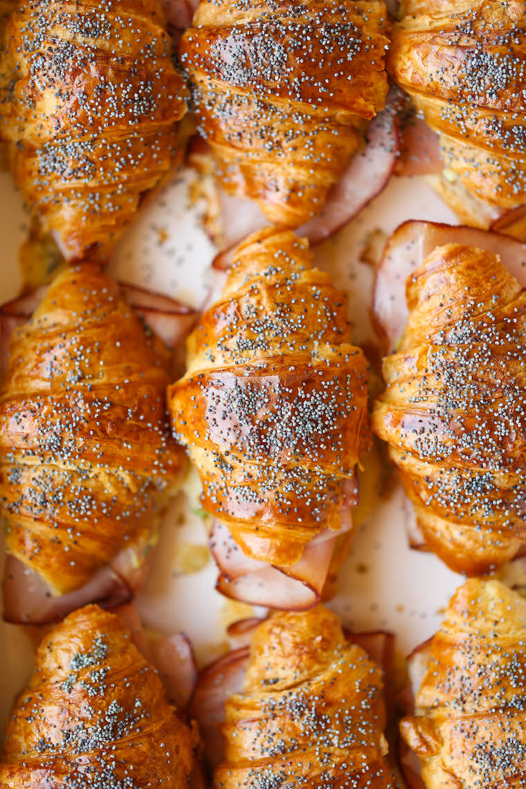 Baked Ham and Cheese Croissants - So so easy to make for a crowd! The mini croissants are toasted and flaky, baked with Dijon-honey, buttery goodness. WHOA.