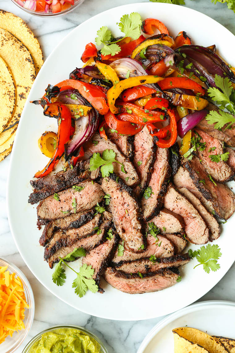 Easy Steak Fajitas - Tender, juicy, melt-in-your-mouth slices of steak with bell peppers and onion. SO SO GOOD. Serve with tortillas, pico and guacamole.