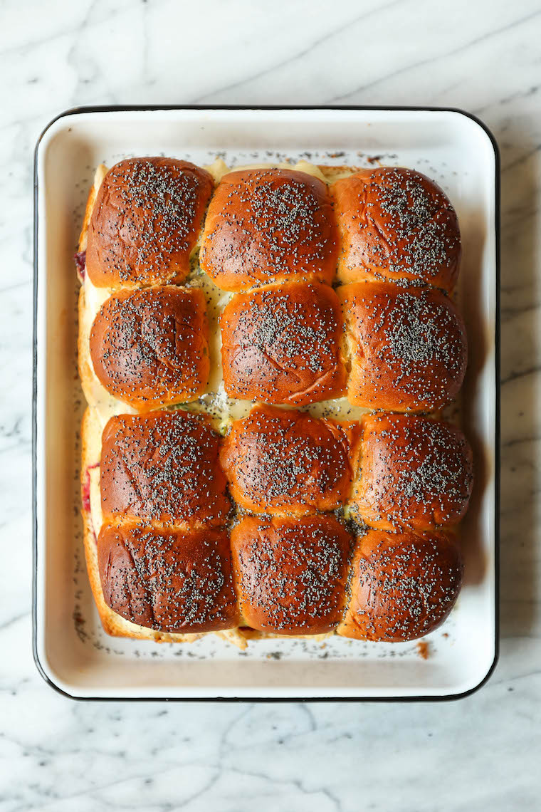 Leftover Thanksgiving Sliders - Leftover turkey, cranberry sauce, Dijon and melted cheese on super buttery Hawaiian rolls. Bake and serve warm! SO SO GOOD.