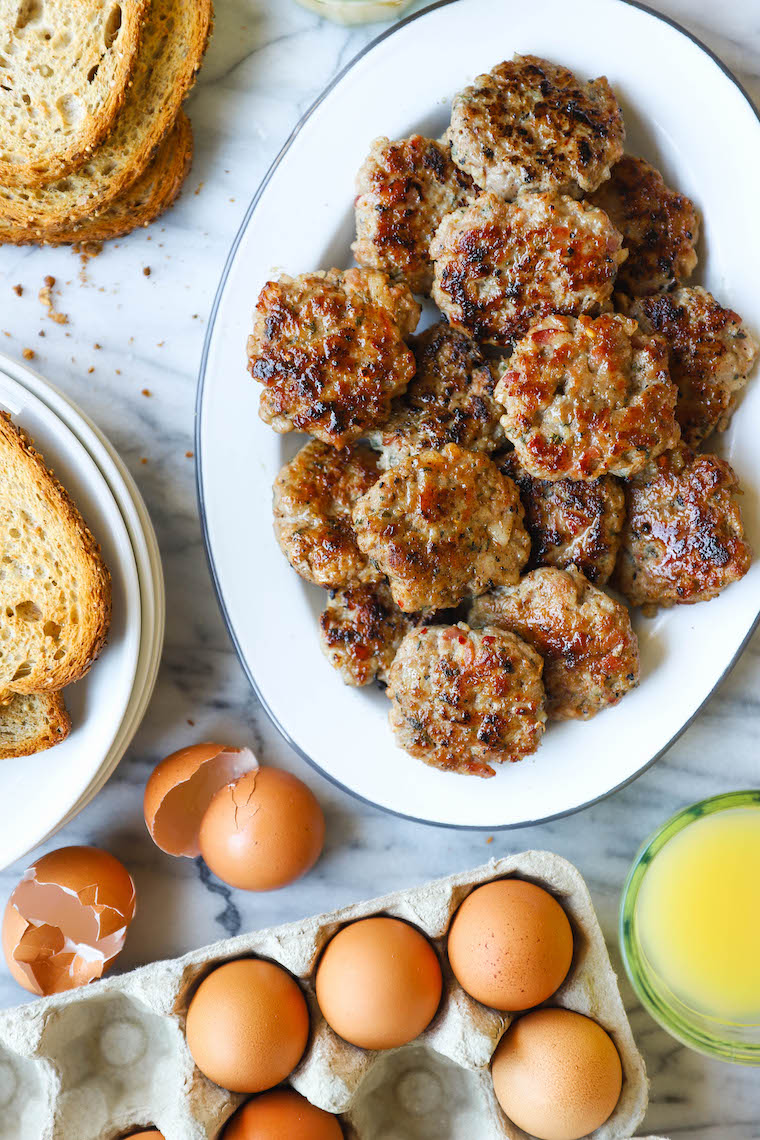 Homemade breakfast sausage patties with a browned, crispy exterior on a plate with bread and egg on the side