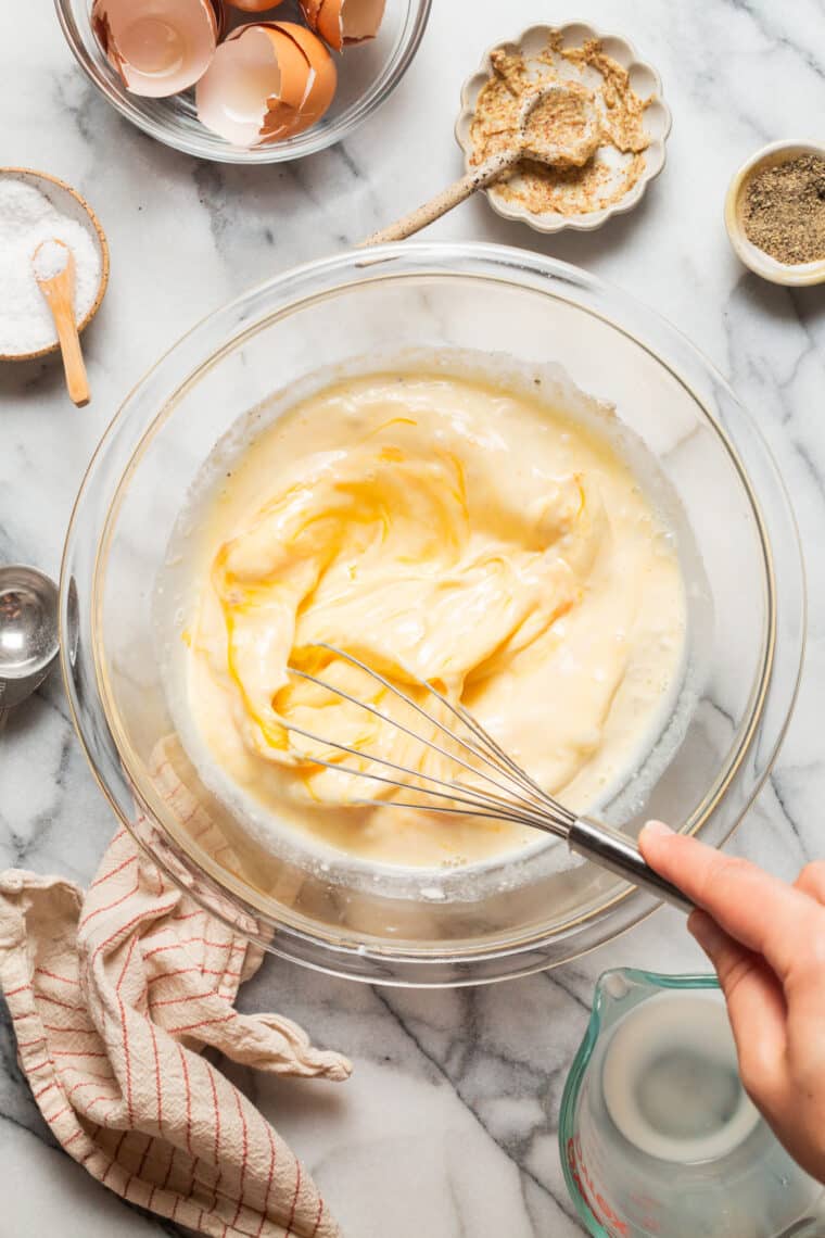 whisking eggs for easy quiche prep